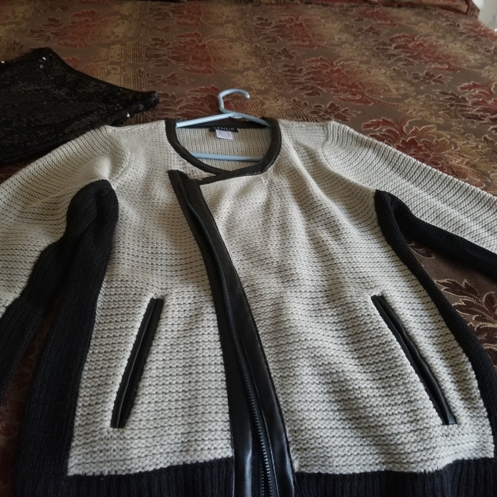 Venus biege and black sweater.